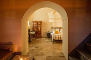 an archway leading into a room with a bedroom at Ikio Concept Santorini in Pirgos