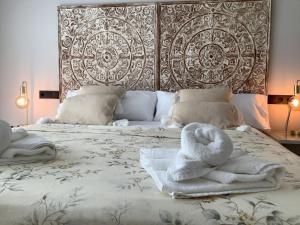 a bedroom with a bed with towels on it at WHITE HOUSE IBIZA in Nuestra Señora de Jesus