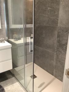 a shower with a glass door in a bathroom at WHITE HOUSE IBIZA in Nuestra Señora de Jesus