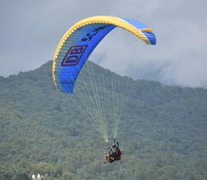 a person flying through the air with a parachute at Rocky Mountain homestay in Dalhousie