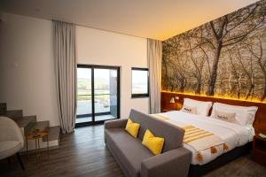 um quarto de hotel com uma cama e um sofá em Xhale Azores em Angra do Heroísmo