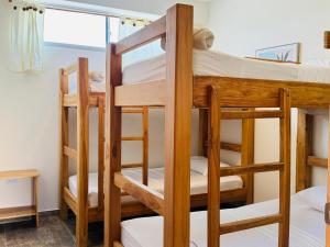 a room with bunk beds in a hostel at Merakai Hostel Rincon del Mar in Rincón