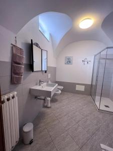a bathroom with two toilets and a sink and a shower at Orchidea in Finale Ligure