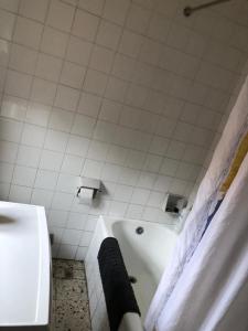 a bathroom with a white tub and a sink at Casa en Picos de Europa in Posada de Valdeón
