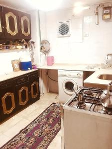 a small kitchen with a stove and a sink at Alam B&B Luxor in Luxor