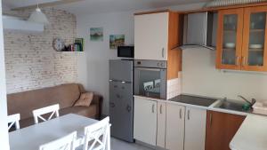 a kitchen and living room with a couch and a table at Helena in Trzin