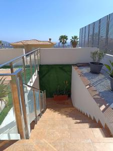 a balcony with a green lawn on a building at Villa Ipanema Benidorm in Finestrat