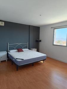 a bedroom with a bed in a room with a window at Villa Ipanema Benidorm in Finestrat