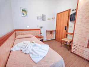 Postel nebo postele na pokoji v ubytování Hotel Rosa