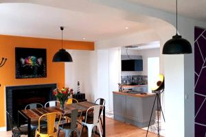 a kitchen and dining room with a table and chairs at Villa de 4 chambres avec piscine privee sauna et jardin clos a La Poterie Cap d'Antifer in La Poterie-Cap-dʼAntifer