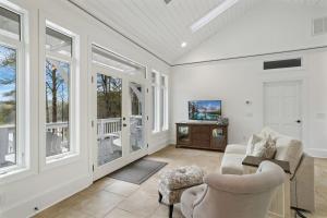 a living room with white walls and windows at Bella Di Lago in Wilkesboro