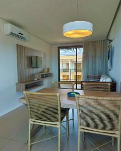 een eetkamer met een houten tafel en stoelen bij Porto das Dunas Boutique Praia Hotel in Aquiraz