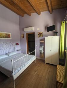 a bedroom with a white bed and a tv at Villa Torri in Torano Nuovo