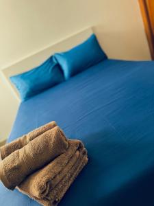 a blue bed with a towel on top of it at Lighthouse in Puerto del Rosario