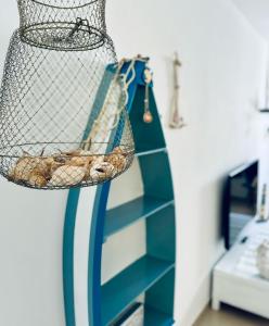 a blue and white shelf with shoes in a basket at Lighthouse in Puerto del Rosario