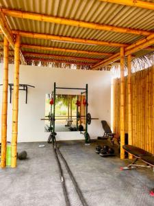 a room with a gym with a mirror and weights at Las casitas del norte in Zorritos