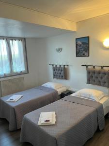 a hotel room with two beds in a room at Hôtel Restaurant Douce France in Saint Alban Auriolles +52 photos
