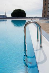 a swimming pool with a faucet in the water at Candelaria vistas al mar in Candelaria