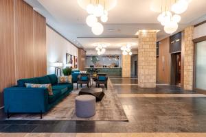 een lobby met een blauwe bank en een tafel bij Sandman Suites Vancouver on Davie in Vancouver