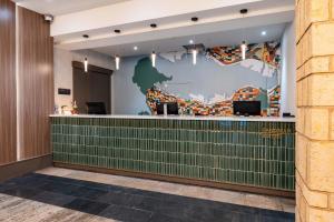 a view of a lobby with a green tile wall at Sandman Suites Vancouver on Davie in Vancouver