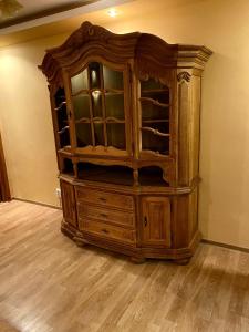 a large wooden cabinet sitting in a room at Apartament lux 3 camere in Roman