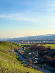 a view of a town from a hill with a road at Nature view Almaty in Karagayly