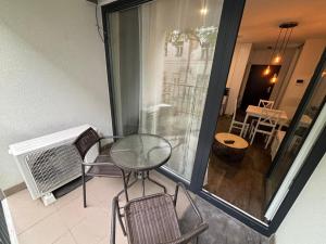 d'un balcon avec une table et des chaises en verre sur la terrasse. dans l'établissement Apartman - Centrum, à Bratislava