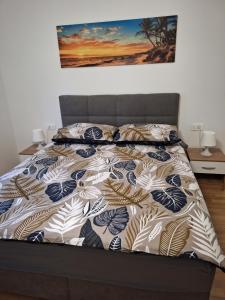 a bed with a comforter and pillows on it at Kuca za odmor Sweet Dreams in Bisko +14 photos