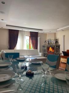 a dining room with a table with wine glasses on it at Villa Kartalkaya in Kındıra