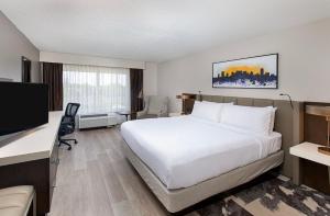 a hotel room with a bed and a flat screen tv at Crowne Plaza Nashville Airport by IHG in Nashville +91 photos