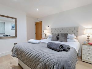 a bedroom with a large bed with two towels on it at 3 Bed in Cawsand 74300 in Kingsand