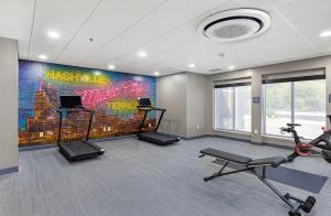 a gym with bikes and a wall with a mural at Crowne Plaza Nashville Airport by IHG in Nashville