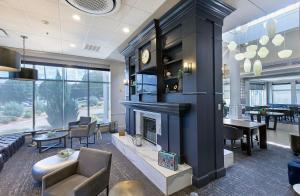 a living room with a fireplace and a dining room at Crowne Plaza Nashville Airport by IHG in Nashville
