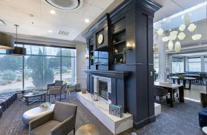 a living room with a fireplace and a dining room at Nash Haus Hotel in Nashville