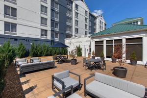 a patio with couches and tables and chairs in front of a building at Crowne Plaza Nashville Airport by IHG in Nashville