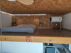 a bedroom with a bed on a wooden platform at l'essentiel in Ault