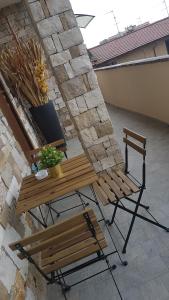 un banco, una mesa y una planta en un patio en ILLUVIA affitto camere, en Cornaredo