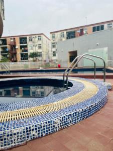 a swimming pool with a yellow and blue tiled coping at ORANGE ISLAND in Lagos