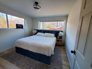 a bedroom with a bed and a television in it at Updated Douglas Apartment, Close to Sandy Beach in Juneau