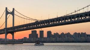 a bridge over the water with a city in the background at Ansik in Busan