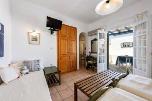 a room with a bed and a couch and a table at Zanneta's House in Naousa