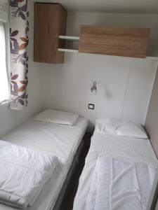 two beds in a small room with white sheets at Domaine de dugny in Onzain