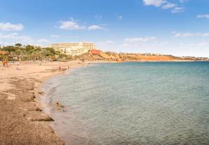 a view of a beach with people in the water at Apartamento Orihuela Costa in Alicante