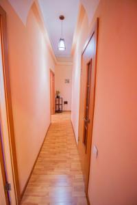 a hallway with a long corridor with a hallwayngthngthngthngthngthngthngth at Квартира посуточно Талдыкорган in Taldykorgan