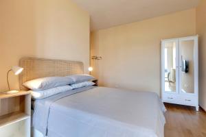 a bedroom with a white bed and a window at Florence Holiday Homes Casa Belfiore in Florence