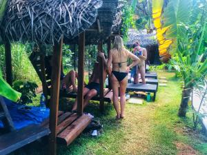 a woman in a bikini standing on a bench at Palmyra Nature Resort Sigiriya in Sigiriya