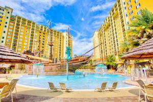a large pool with a pirate ship in the middle at Cozy 2BR Condo Resort Spa with Pirate Pool in Kissimmee