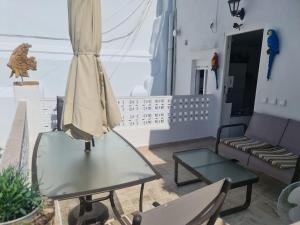 a living room with a couch and a glass table at El Faro del Manteca in Cádiz