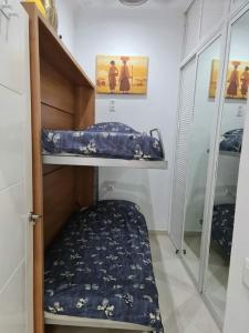 a room with two bunk beds and a mirror at El Faro del Manteca in Cádiz