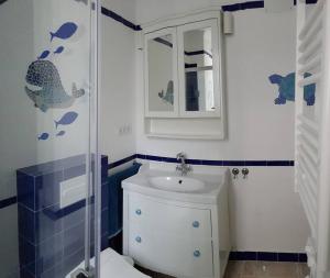 a bathroom with a toilet and a sink and a mirror at El Faro del Manteca in Cádiz